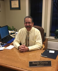 Picture of President Randy Garcia sitting at his desk.