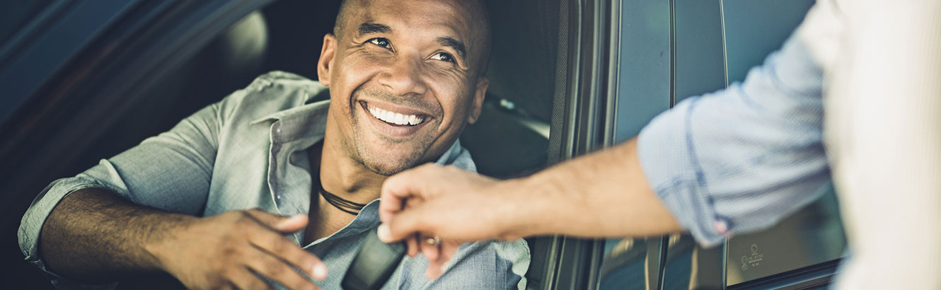 Man receiving keys to new car